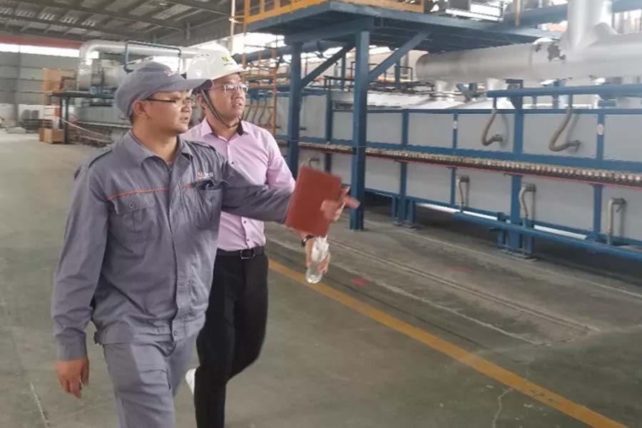 AdTech aluminum casting production line with engineers and leadership inspecting operations, demonstrating professional scale and expertise