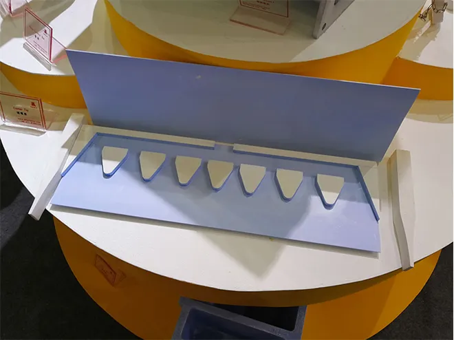 Open view of a ceramic casting tip showing internal components including caster tip, spacer, and hard/soft ears in aluminum pouring system